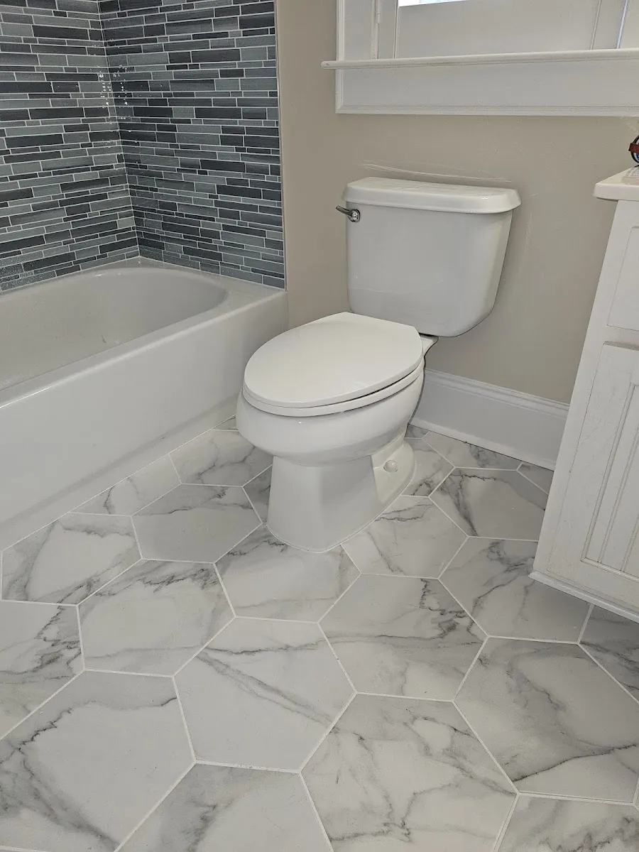 Bathroom with a new toilet and hexagon tile floor