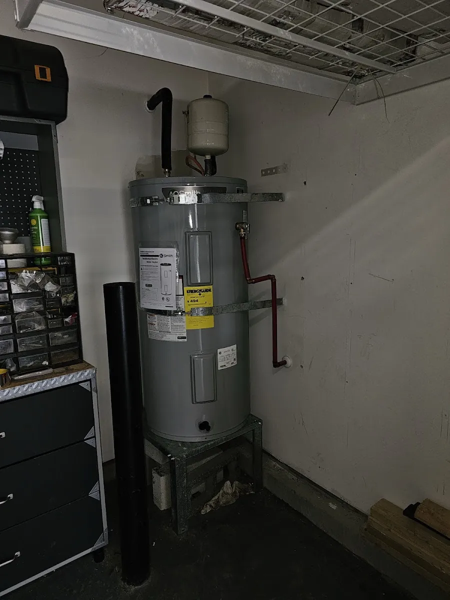 New electric water heater installed in a garage
