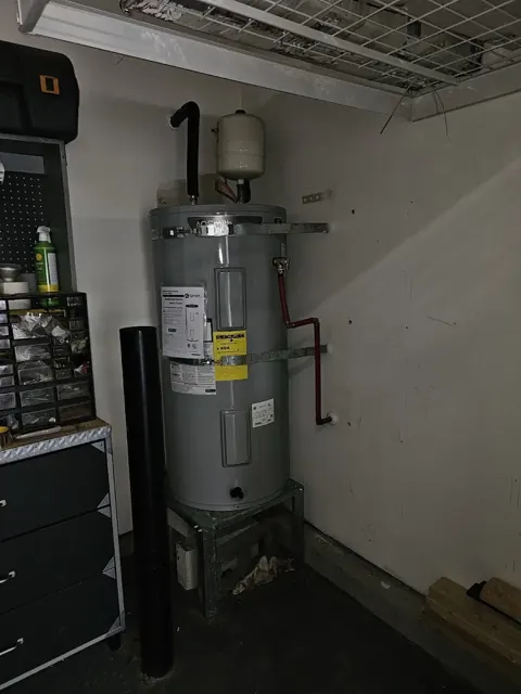 New electric water heater installed in a garage