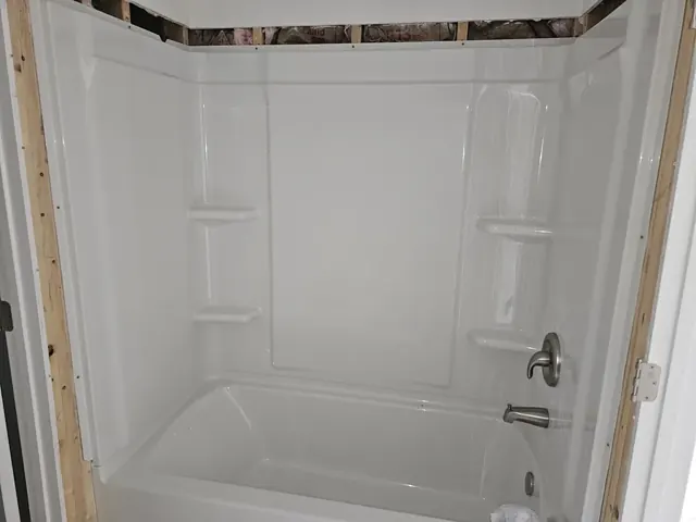 New tub and shower unit installed during a bathroom remodel