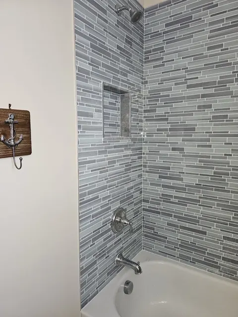 Tiled tub and shower surround with new fixtures